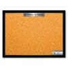 A bulletin board with orange paper and black frame.